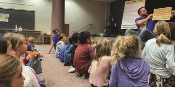 Volunteer Brad Esbenshade leads the children at Landisville Primary Center’s Good News Club in learning 1 Corinthians 10:31.