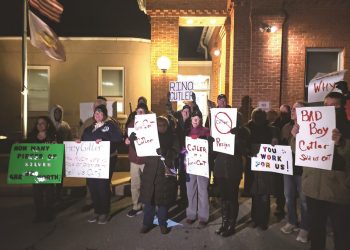 Protesters hold signs outside Rep. Bryan Cutler's constituent meeting Jan. 26 at the Strasburg Township Municipal Building.