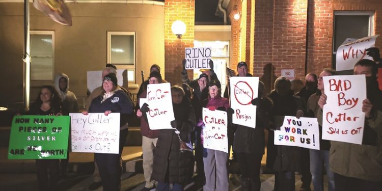 Protesters hold signs outside Rep. Bryan Cutler's constituent meeting Jan. 26 at the Strasburg Township Municipal Building.