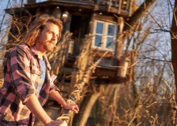Blake Ringenberg stands outside the Lord of the Rings treehouse he designed and built in Mount Joy.