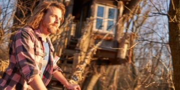 Blake Ringenberg stands outside the Lord of the Rings treehouse he designed and built in Mount Joy.