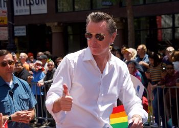 Gavin Newsom walks in the 2019 Gay Pride Parade in San Francisco.